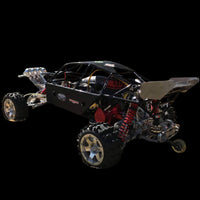 Black off-road vehicle chassis with visible mechanical components on a black background