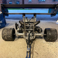 Close-up of a mechanical vehicle component on a street.