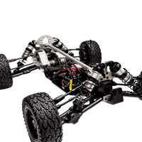 Close-up of a mechanical vehicle chassis with visible suspension and tires on a white background