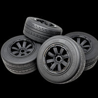 Four model tires with visible treads on a black background