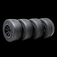 Four tires arranged in a row on a black background