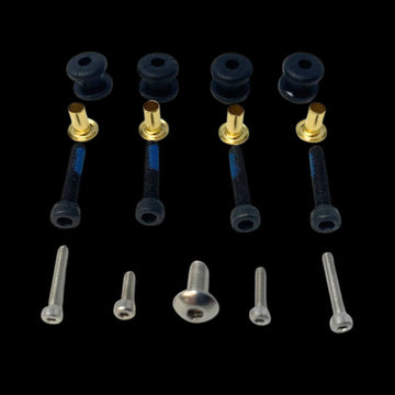 An assortment of RC model vehicle spare hardware including screws and fasteners.