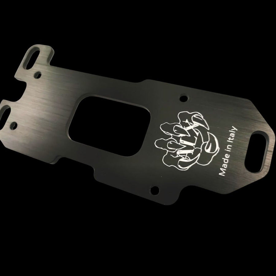 Metal engine mounting plate with brand logo and 'Made in Italy' text on a black background