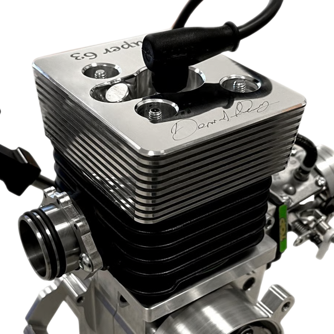 Close-up of a silver engine block with visible branding on a white background