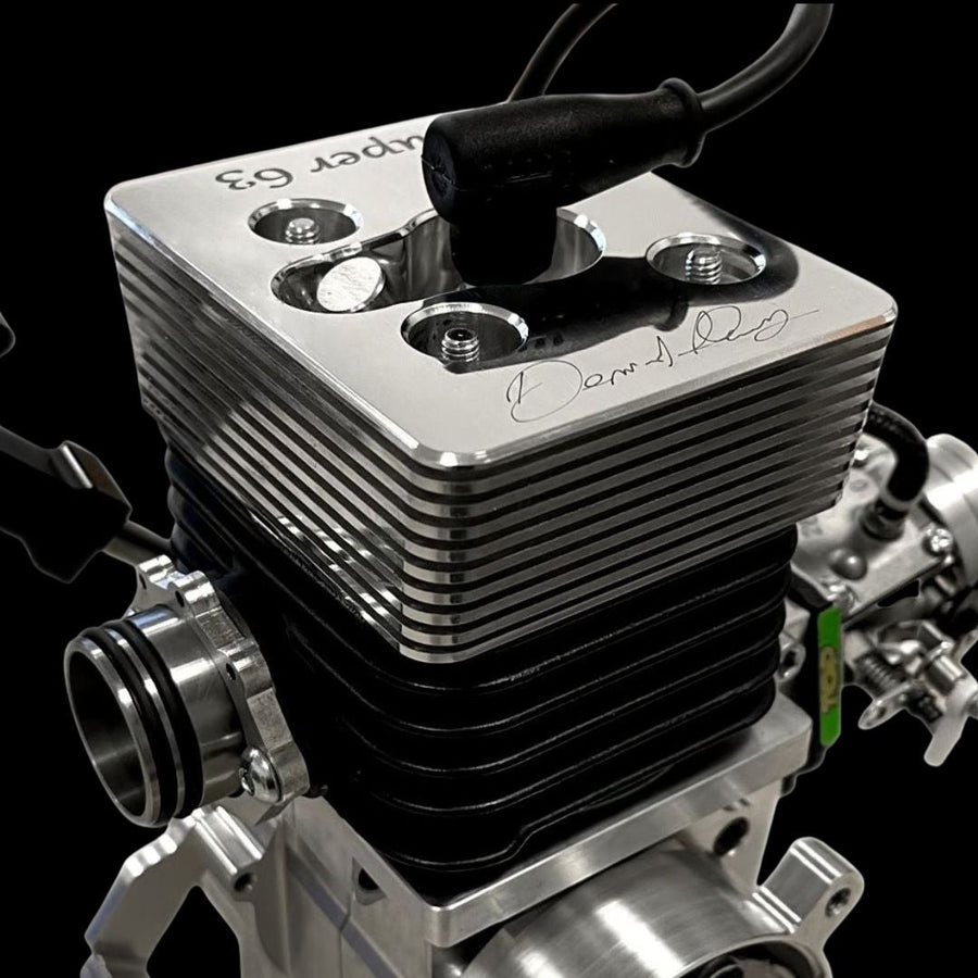 Close-up of a metallic engine block with visible branding on a black background