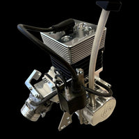 Metallic engine block with various components on a black background