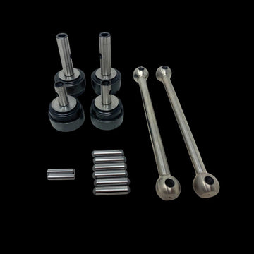 A set of metal dogbone kit parts for a remote control toy, including shafts and pins, displayed on a clear surface.