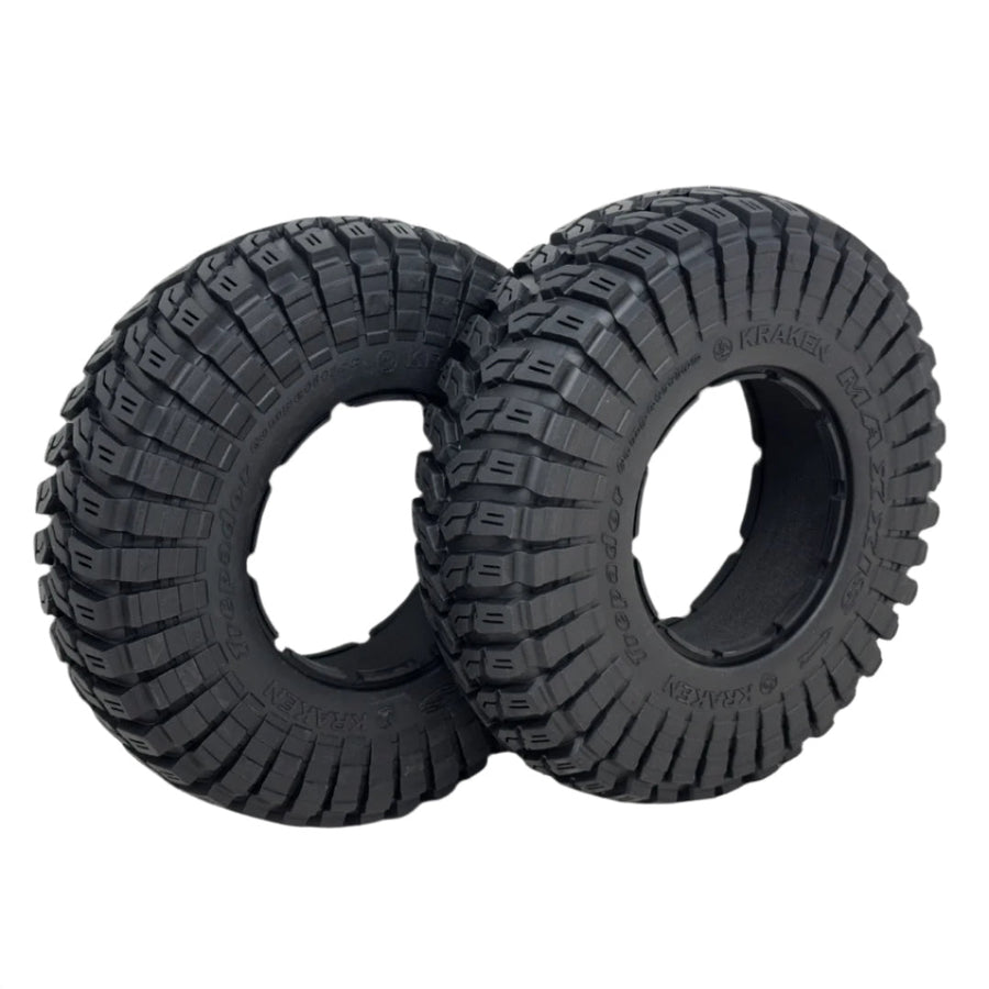 Two black off-road tires with tread pattern on a white background