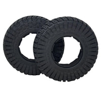 Two black tires with tread patterns on a transparent background