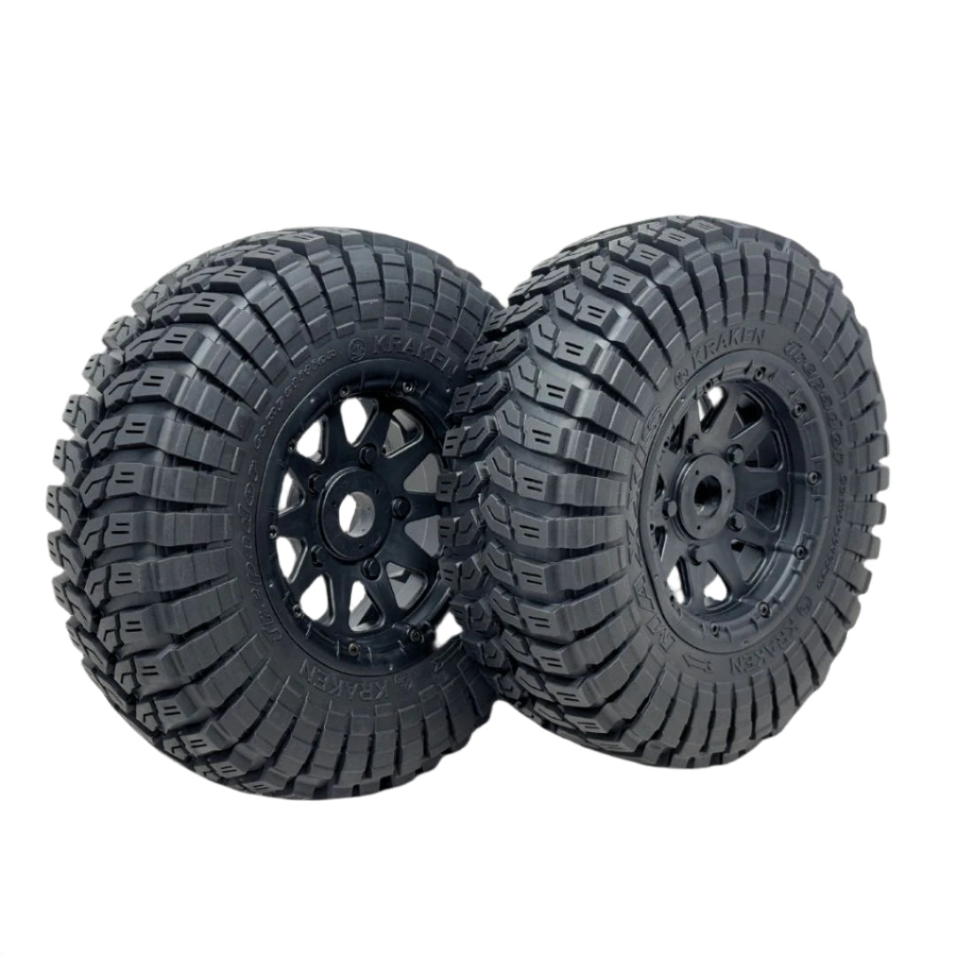 Two black off-road tires with tread patterns on a transparent background