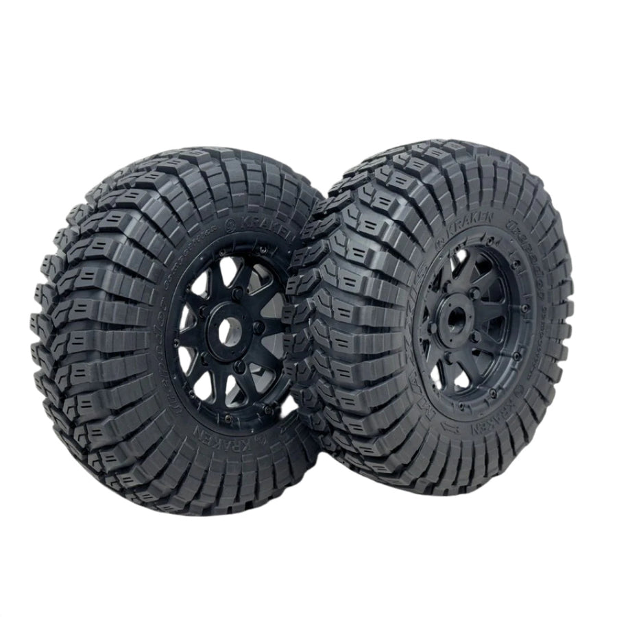 Two black off-road tires with tread patterns on a transparent background