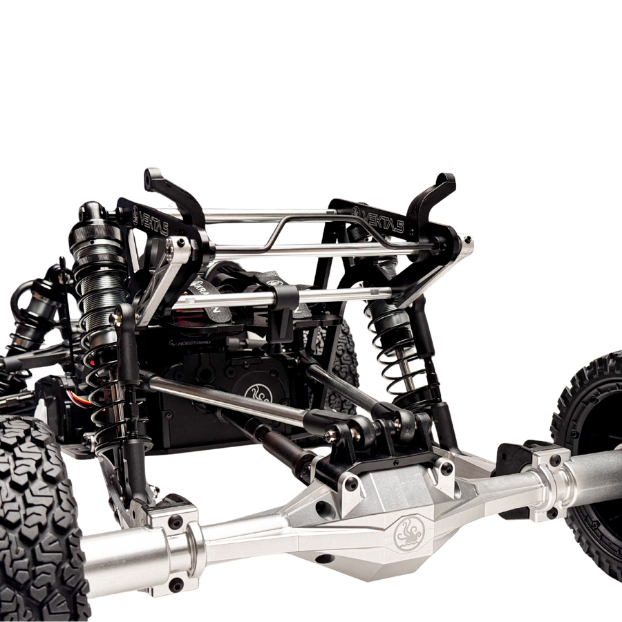Close-up of a detailed metal chassis with suspension components on a white background