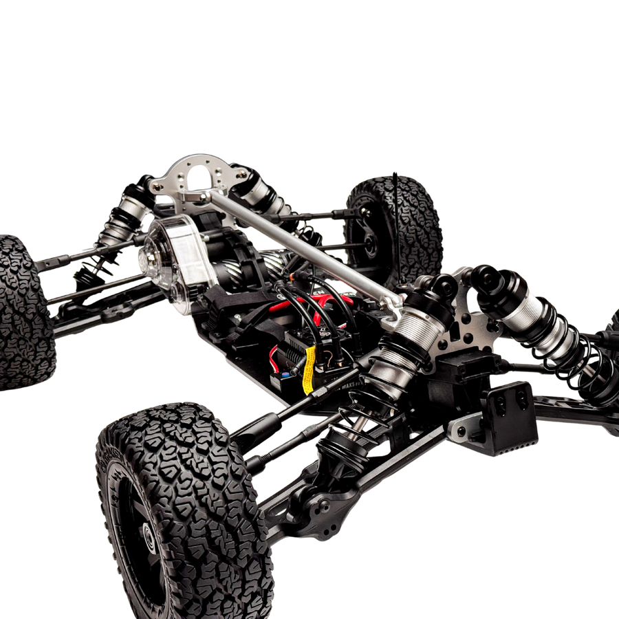 Close-up of a mechanical vehicle chassis with visible suspension and tires on a white background