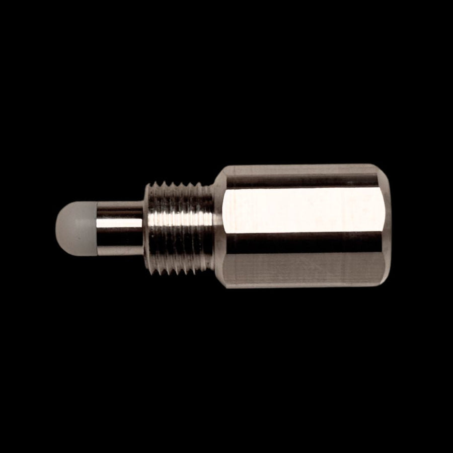 A silver-colored metal RC engine piston stopper against a black background.