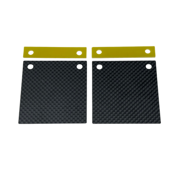 Two black carbon fiber plates with gold straps on a white background