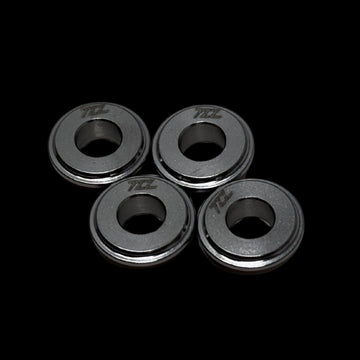 Four metallic rings with 'TZZ' branding on a black background